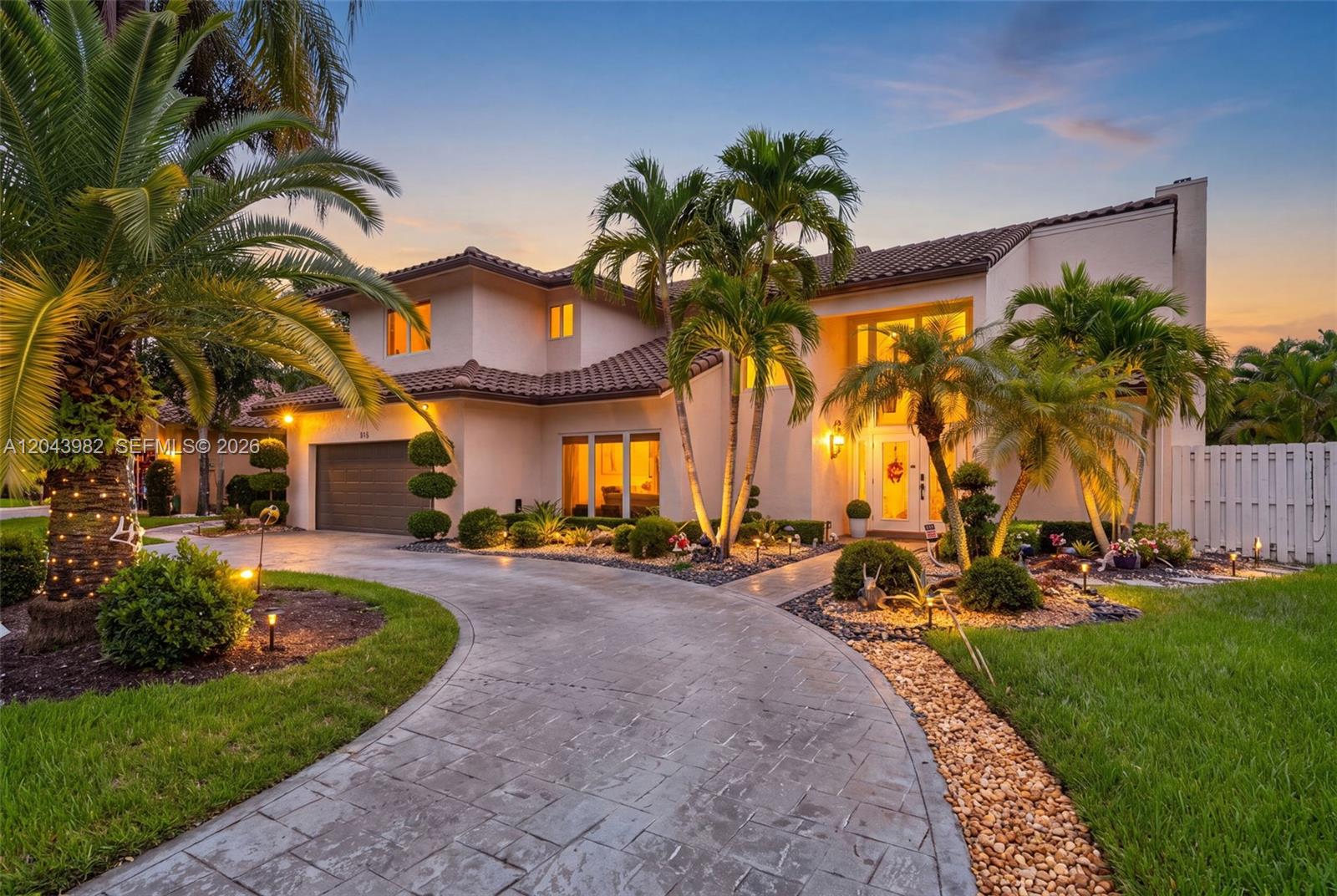A two-story stucco house with a tiled roof, palm trees, and a curved stone driveway — 962 SW 93rd Ter, Plantation FL 33324, PLANTATION, FL