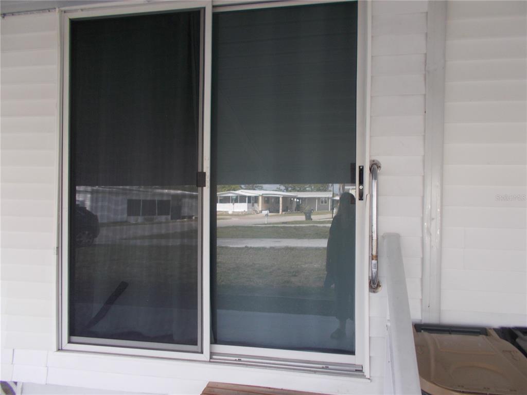 A sliding glass door with a screen is installed on the exterior of a home — 5154 PALENA BOULEVARD, NORTH PORT, FL