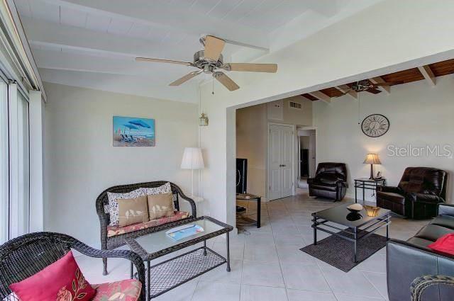 A living room with wicker furniture, a ceiling fan, and tile flooring — 6006 MIDNIGHT PASS ROAD UNIT 64, SARASOTA, FL