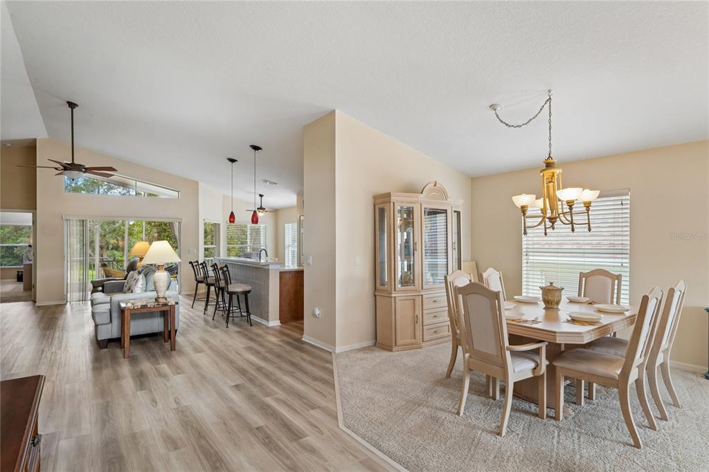 A dining area with a hutch and table sits beside a living room and kitchen — 363 QUANE AVENUE, SPRING HILL, FL