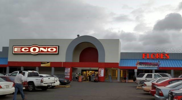 An exterior view of a commercial shopping center featuring an Econo supermarket and a flower shop — PR-111 Km. 20.3 PR-111 KM. 20.3, SAN SEBASTIAN, PR