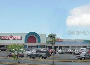A parking lot sits in front of a commercial shopping center with an Econo grocery store — PR-111 Km. 20.3 PR-111 KM. 20.3, SAN SEBASTIAN, PR