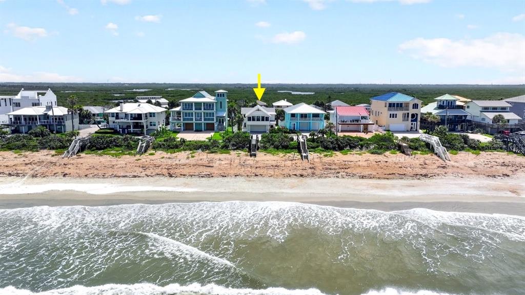 An aerial view shows a row of beachfront houses with a yellow arrow pointing down — 6118 S ATLANTIC AVENUE, NEW SMYRNA BEACH, FL