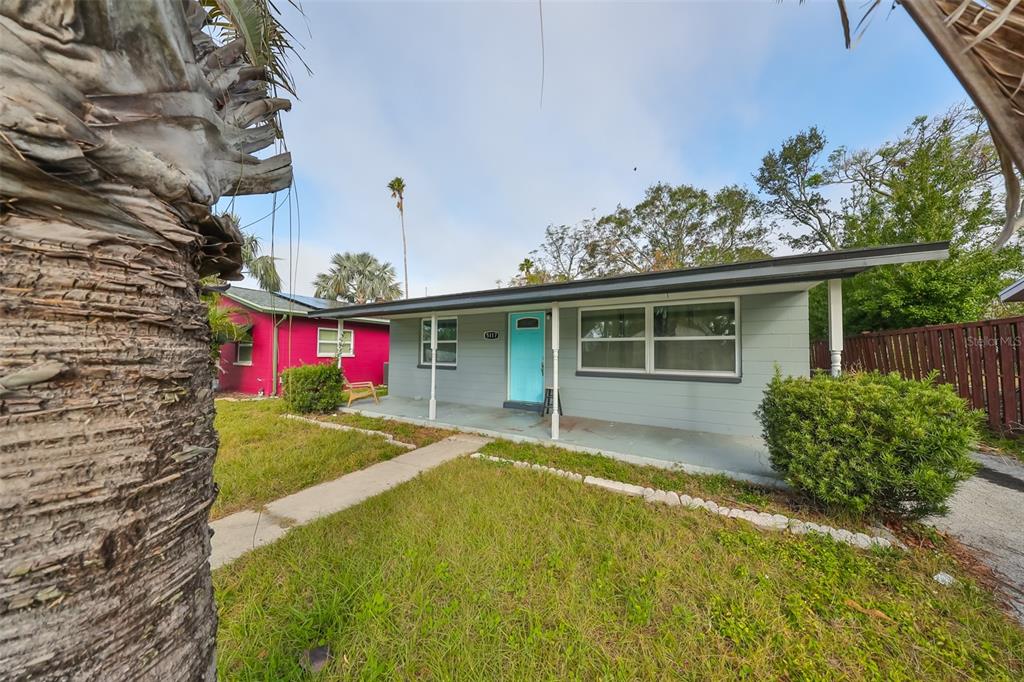 A single-story house with light gray siding, a bright blue door, and a front porch — 5117 12TH AVE S, GULFPORT, FL UNIT 33707, GULFPORT, FL