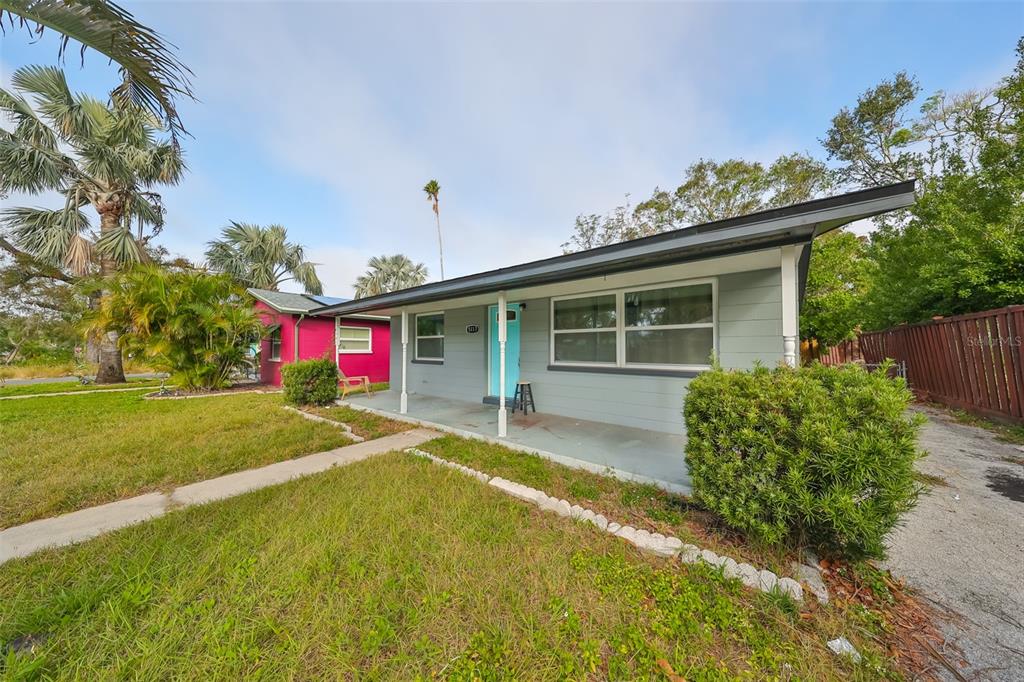 A single-story house with gray siding, a light blue door, and a covered front porch — 5117 12TH AVE S, GULFPORT, FL UNIT 33707, GULFPORT, FL