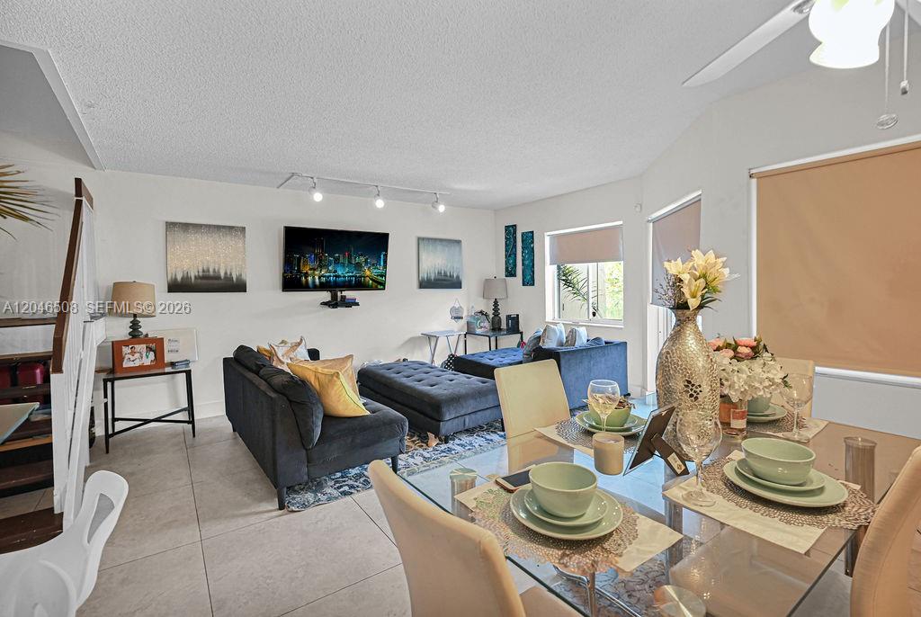 A living and dining area features tile floors, a sectional sofa, and a glass table — 7887 NW 7th Ct, Plantation FL 33324, PLANTATION, FL