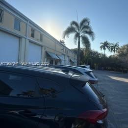 A view of a commercial warehouse building exterior with parked cars in the foreground — 2120 Anntom Dr # 2, Dania Beach FL 33312, DANIA BEACH, FL