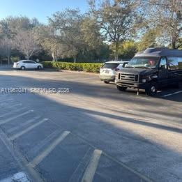 A parking lot with a black van and a white sedan parked near trees — 2120 Anntom Dr # 2, Dania Beach FL 33312, DANIA BEACH, FL