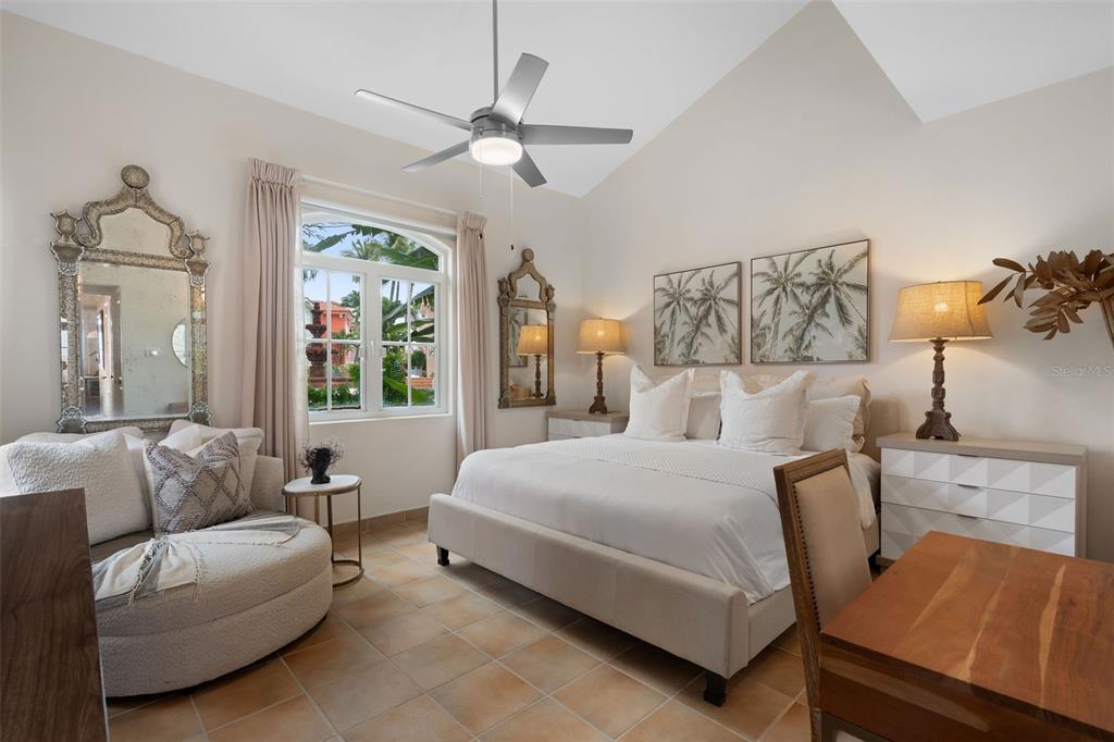 A bedroom features a king bed, a circular chair, tiled floors, and a vaulted ceiling — 1000 AVENUE EL CONQUISTADOR UNIT 5151, FAJARDO, PR