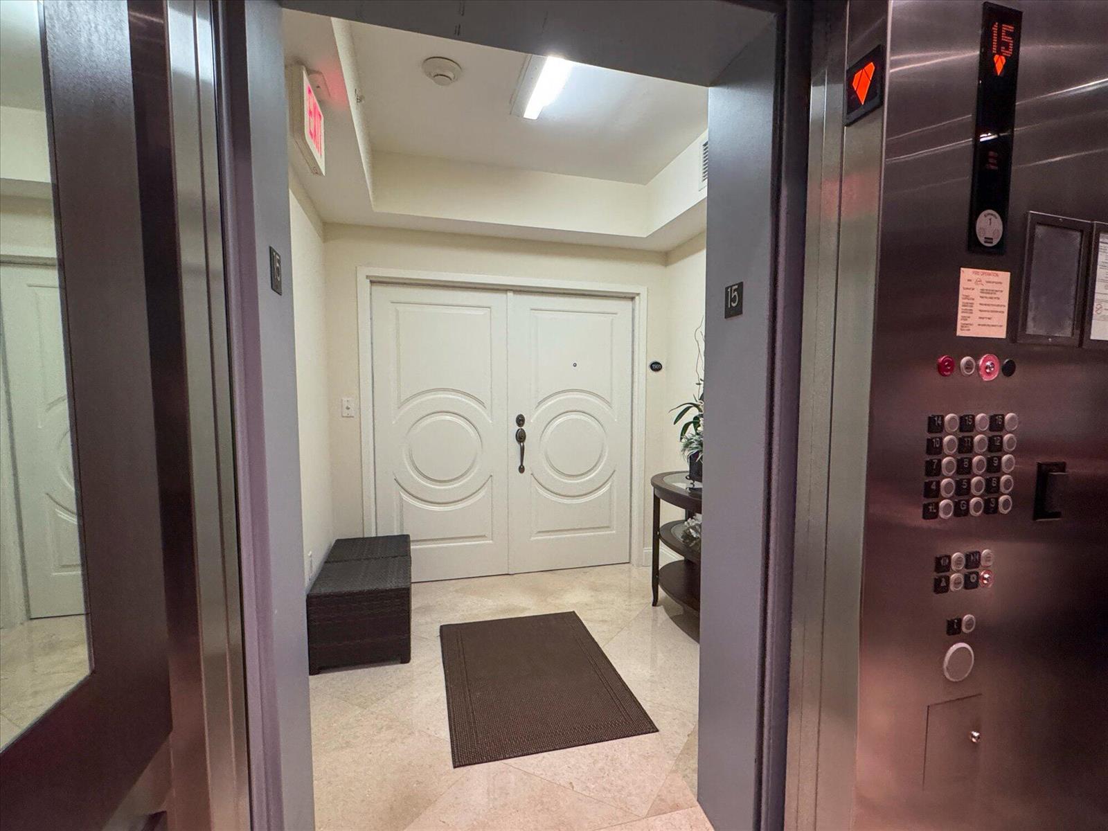A view from inside an elevator looking out toward a double-door entryway with tile flooring — 801 Briny Avenue # 1501, Pompano Beach FL 33062, POMPANO BEACH, FL