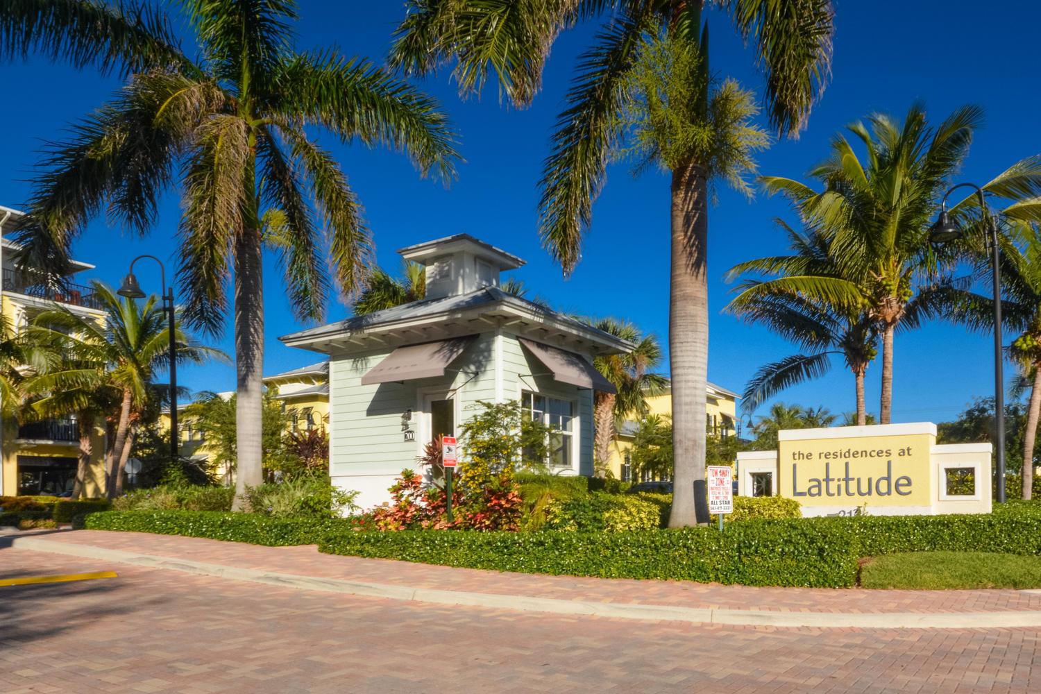 A light green guardhouse stands next to a sign for The Residences at Latitude — 3120 E Latitude Circle E # 101s, Delray Beach FL 33483, DELRAY BEACH, FL