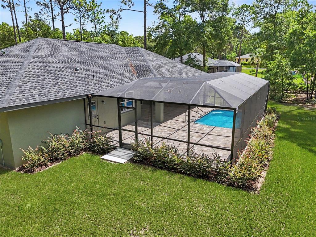 An aerial view of a house with a screened-in pool and patio in the backyard — 20638 SW 88 PLACE ROAD, DUNNELLON, FL