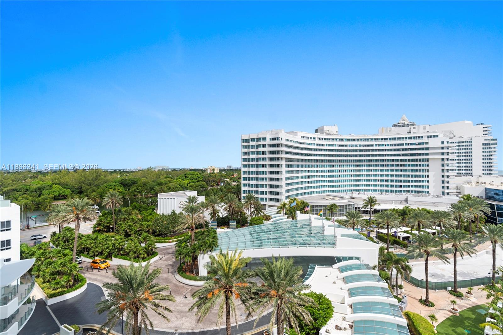 An elevated exterior view shows a large white hotel building surrounded by palm trees — 4391 Collins Ave # 803, Miami Beach FL 33140, MIAMI BEACH, FL