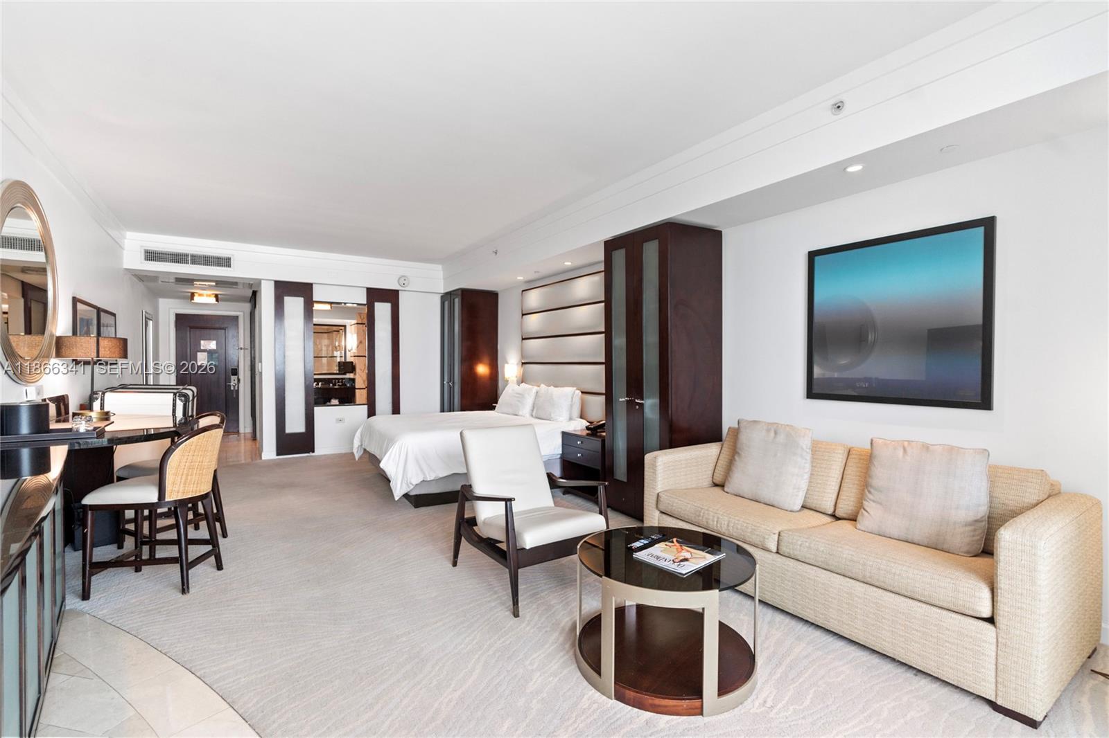 A hotel room features a bed, a seating area with a sofa, and a dining table — 4391 Collins Ave # 803, Miami Beach FL 33140, MIAMI BEACH, FL