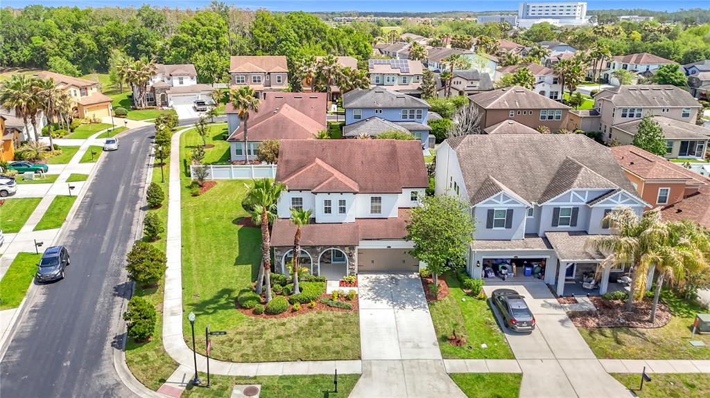 A two-story house with a stone facade, arched entryway, and a two-car garage — 27387 CAYENNE LANE, WESLEY CHAPEL, FL