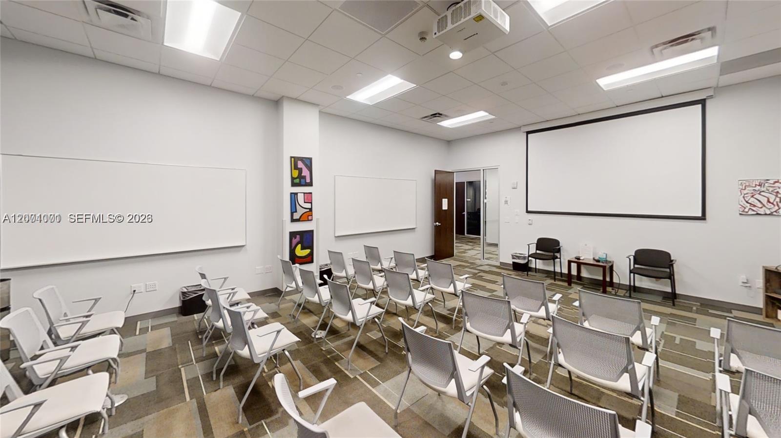 A conference room features rows of chairs, whiteboards, a projector screen, and carpeted flooring — 1501 Biscayne Blvd, FL 33132, FL