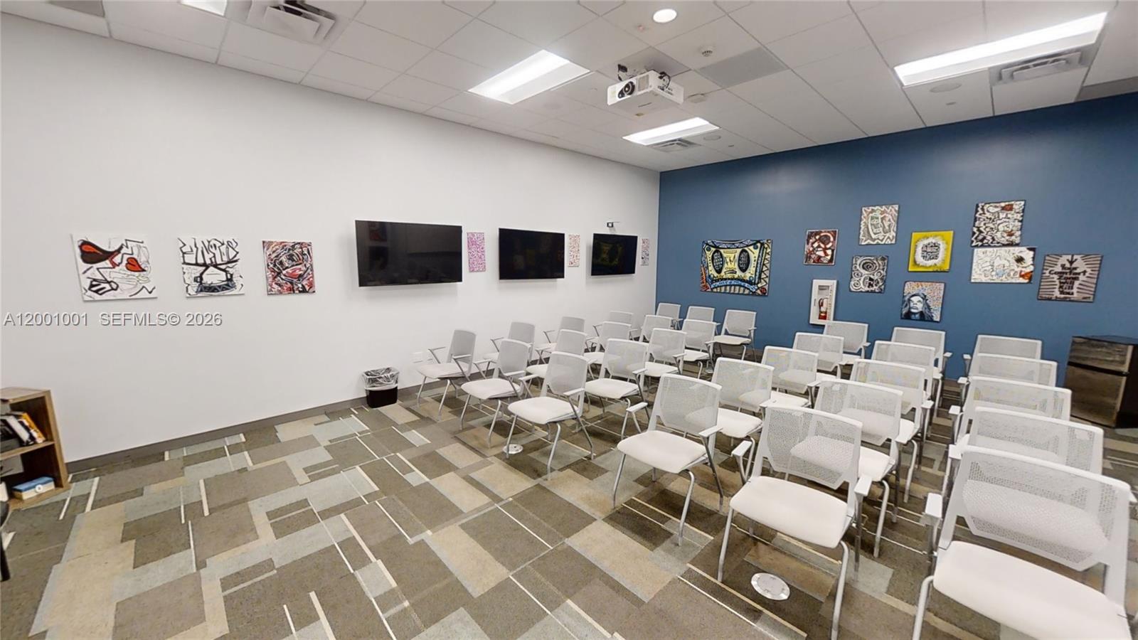 A classroom or meeting room features white walls, a blue accent wall, and rows of chairs — 1501 Biscayne Blvd, FL 33132, FL