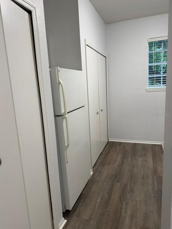 A white refrigerator stands in a room with light gray walls and wood-look flooring — 1321 ARBOR VISTA  LOOP UNIT 117, LAKE MARY, FL