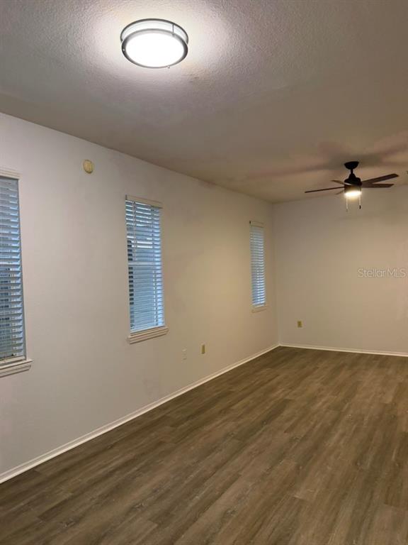 A room with light-colored walls, wood-look flooring, three windows with blinds, and two ceiling fixtures — 1321 ARBOR VISTA  LOOP UNIT 117, LAKE MARY, FL