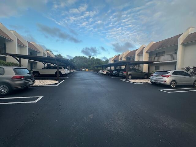 An outdoor parking lot with covered spaces between two residential apartment buildings — 2975 SW 22nd Avenue # 2020, Delray Beach FL 33445, DELRAY BEACH, FL
