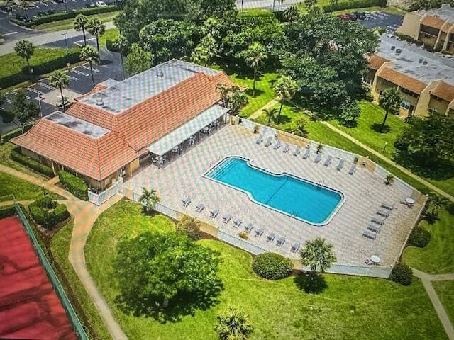 An aerial view shows a community clubhouse with a tile roof and an outdoor swimming pool — 2975 SW 22nd Avenue # 2020, Delray Beach FL 33445, DELRAY BEACH, FL