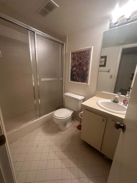 A bathroom featuring a shower with sliding glass doors, a toilet, and a vanity sink — 2975 SW 22nd Avenue # 2020, Delray Beach FL 33445, DELRAY BEACH, FL