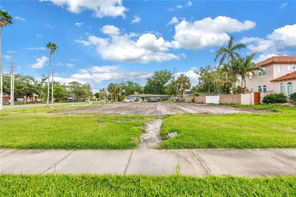 A vacant, cleared residential lot with grass in the foreground and palm trees nearby — 515 SNELL ISLE BOULEVARD NE, ST PETERSBURG, FL