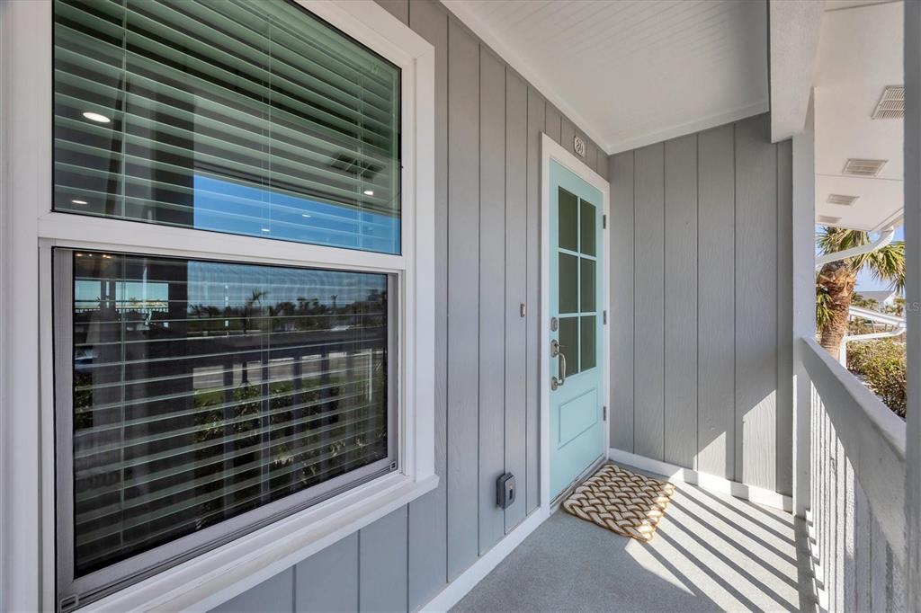 A light blue door and a window with blinds are on a gray-sided porch — 6021 BOCA GRANDE CAUSEWAY UNIT G80, BOCA GRANDE, FL