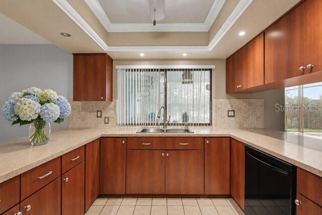 A kitchen features wood cabinets, a tiled backsplash, a double sink, and a large window — 8012 PAGODA DRIVE, SPRING HILL, FL