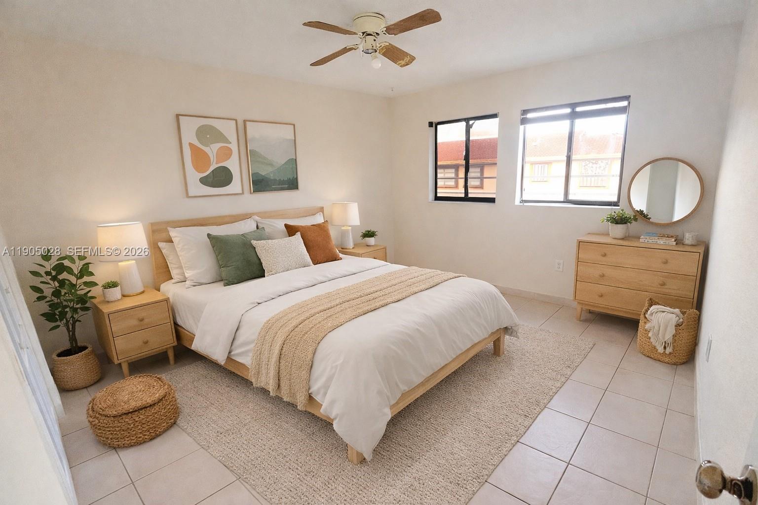 A bedroom features a wooden bed frame, light-colored walls, tiled flooring, and two windows — 5712 W 25th Ct # 5712, Hialeah FL 33016, HIALEAH, FL