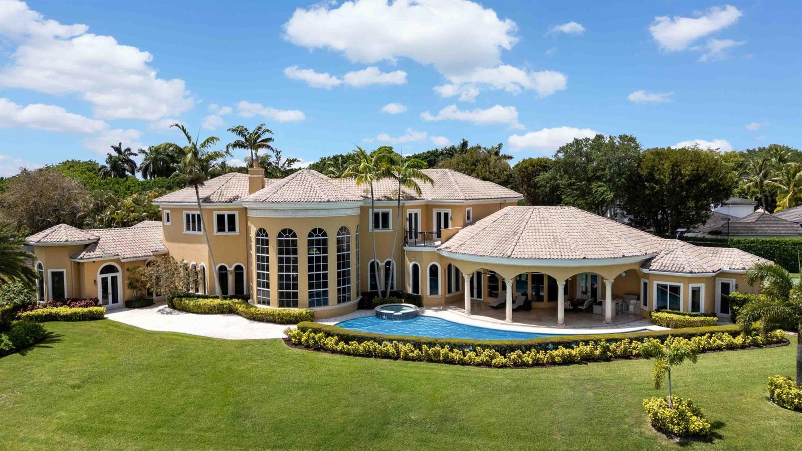 An aerial view of a two-story tan stucco house with a tiled roof and pool — 18118 Daybreak Drive, Boca Raton FL 33496, BOCA RATON, FL