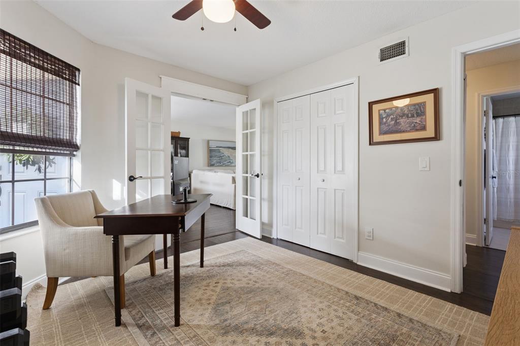 A home office with a desk, chair, area rug, French doors, and a closet — 1533 SPRINGTIME LOOP, WINTER PARK, FL