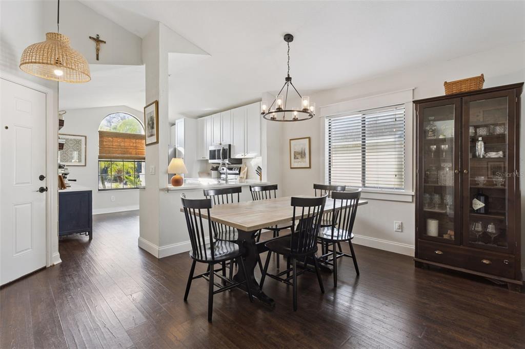 A dining area with a wooden table, black chairs, and a dark wood china cabinet — 1533 SPRINGTIME LOOP, WINTER PARK, FL