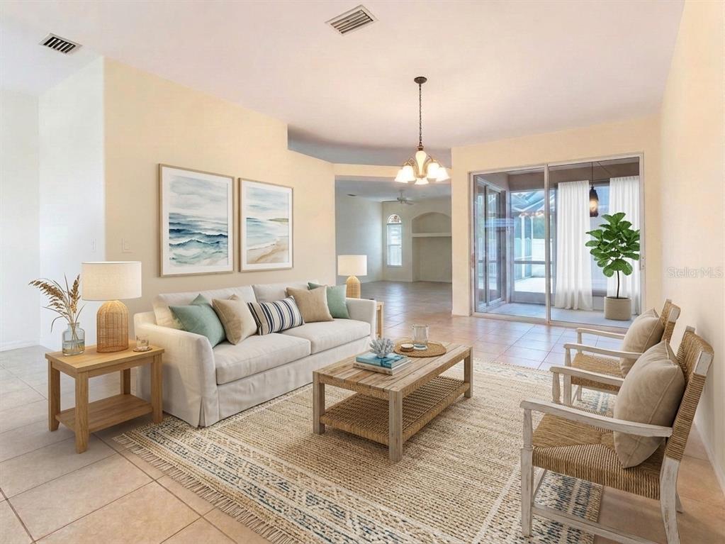 A living room with a sofa, two chairs, a coffee table, and sliding glass doors — 1487 EVANGELINA LANE, NORTH PORT, FL