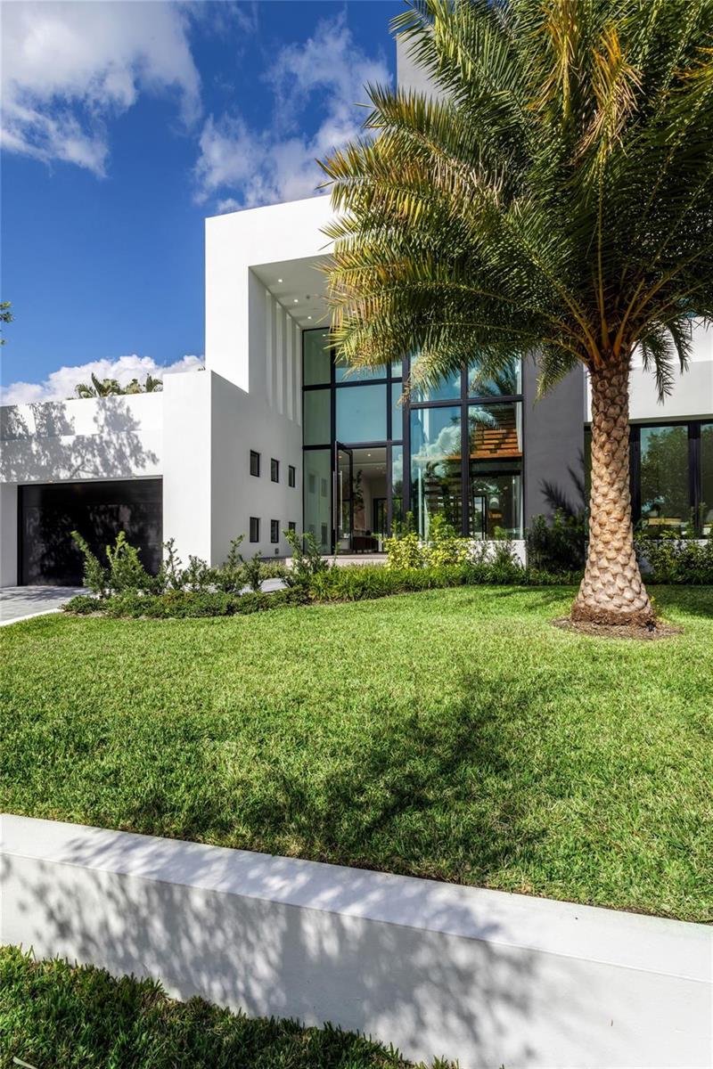 A modern white house with a large glass entryway and a palm tree in front — 3205 Leigh Road, Pompano Beach FL 33062, POMPANO BEACH, FL