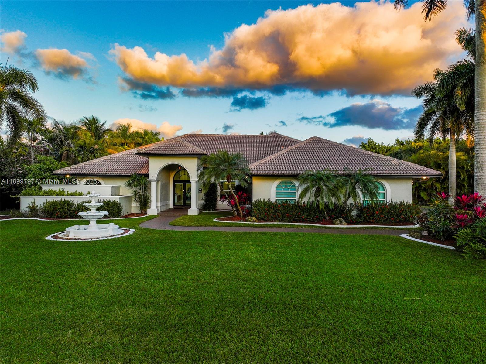 A single-story house with a tiled roof, arched entryway, and a front yard fountain — 3152 SW 147th Ave, Davie FL 33330, DAVIE, FL