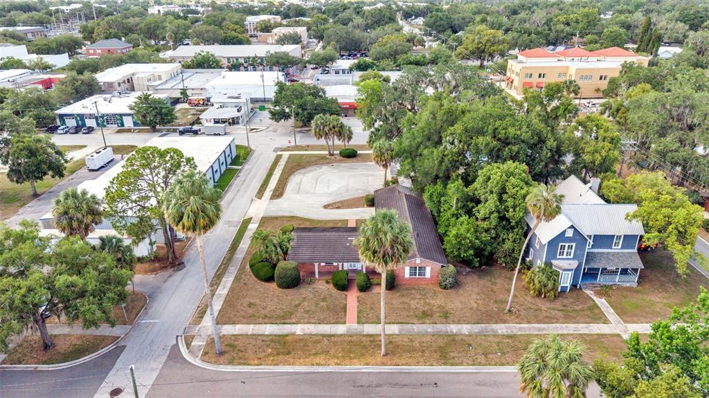 An aerial view shows a residential lot with two houses, palm trees, and a parking area — 510 E PARKER STREET, BARTOW, FL