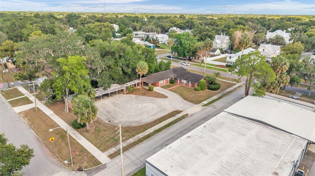 An aerial view shows a single-story brick building with a carport and large parking area — 510 E PARKER STREET, BARTOW, FL