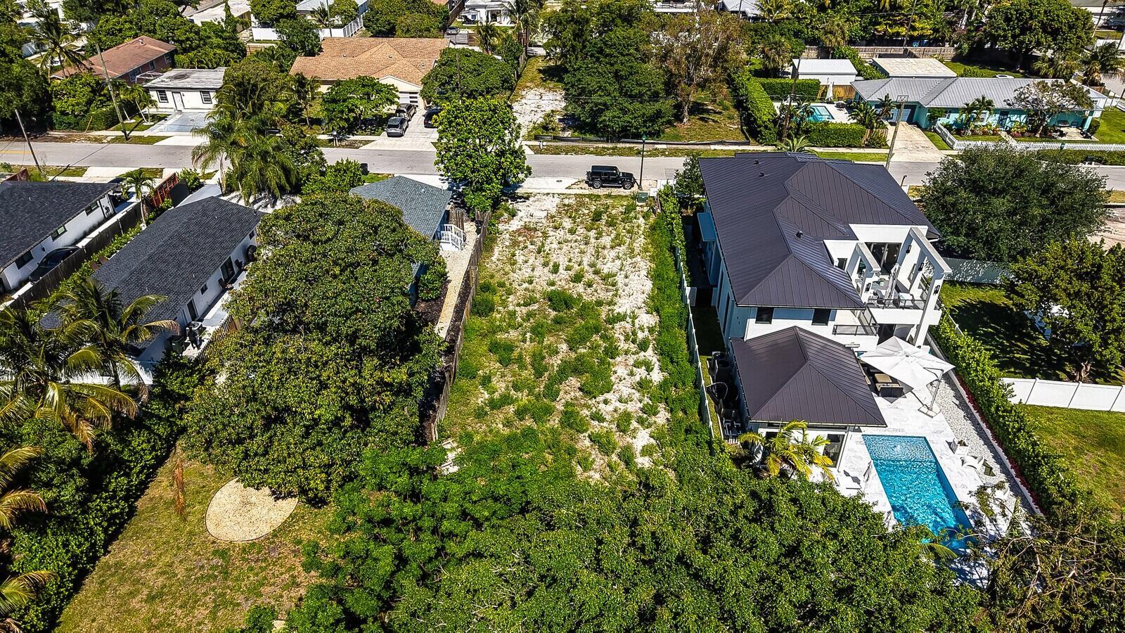 An aerial view shows a vacant lot situated between two residential properties with swimming pools — 618 SE 2nd Avenue, Delray Beach FL 33483, DELRAY BEACH, FL
