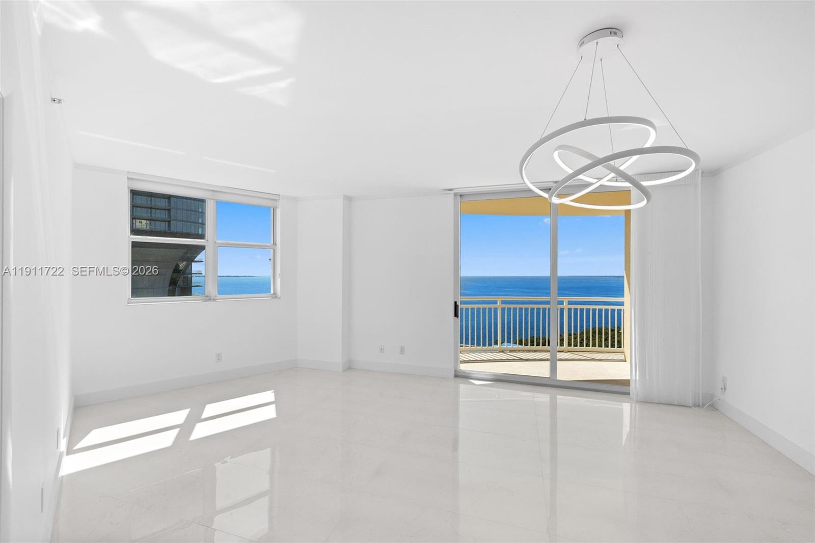 An aerial view shows a tall residential building marked with a pin near a bridge — 2475 Brickell Ave # 1907, Miami FL 33129, MIAMI, FL