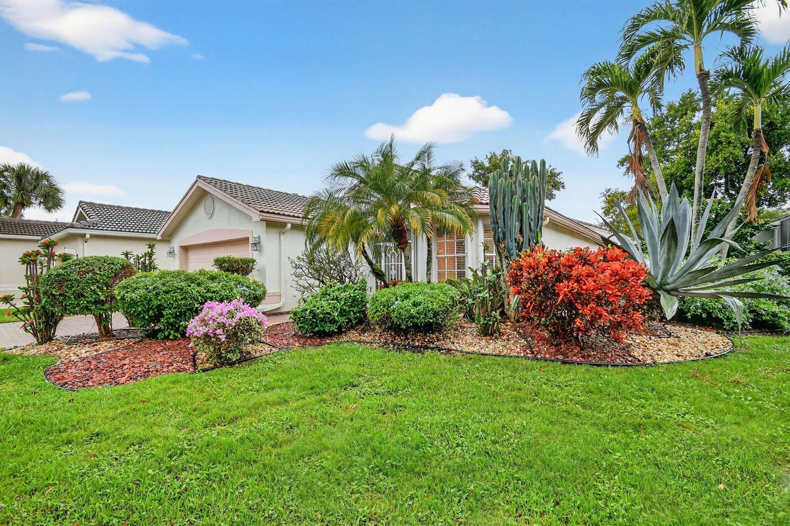 A single-story house with a tiled roof, a green lawn, and a variety of desert landscaping — 6568 Malta Drive, Boynton Beach FL 33437, BOYNTON BEACH, FL
