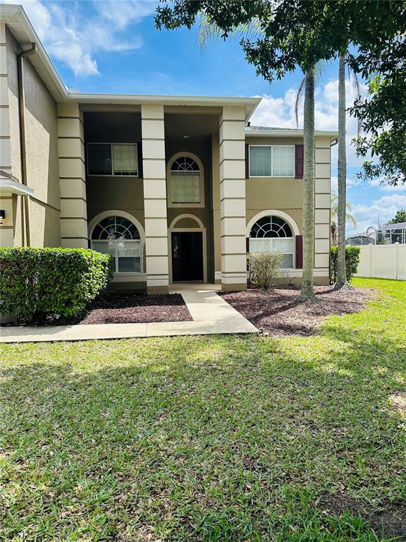 The exterior of a two-story house features a recessed entryway with large white columns — 2283 STONE CROSS CIRCLE, ORLANDO, FL