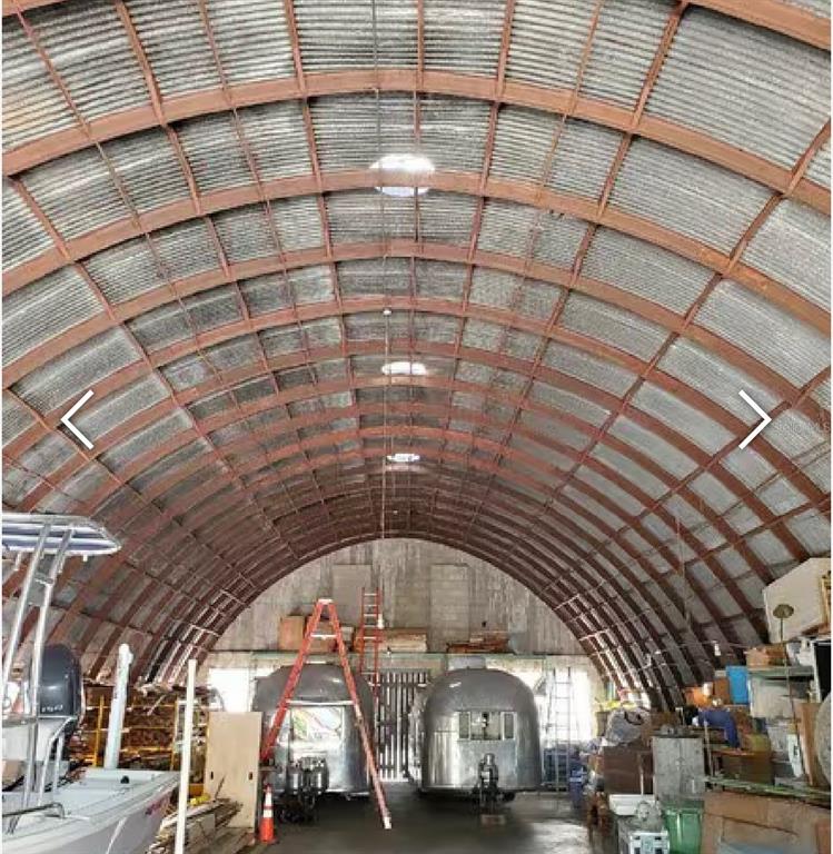 A large, arched metal storage building contains two vintage silver trailers and a boat — 3205 N FLORIDA AVENUE, TAMPA, FL