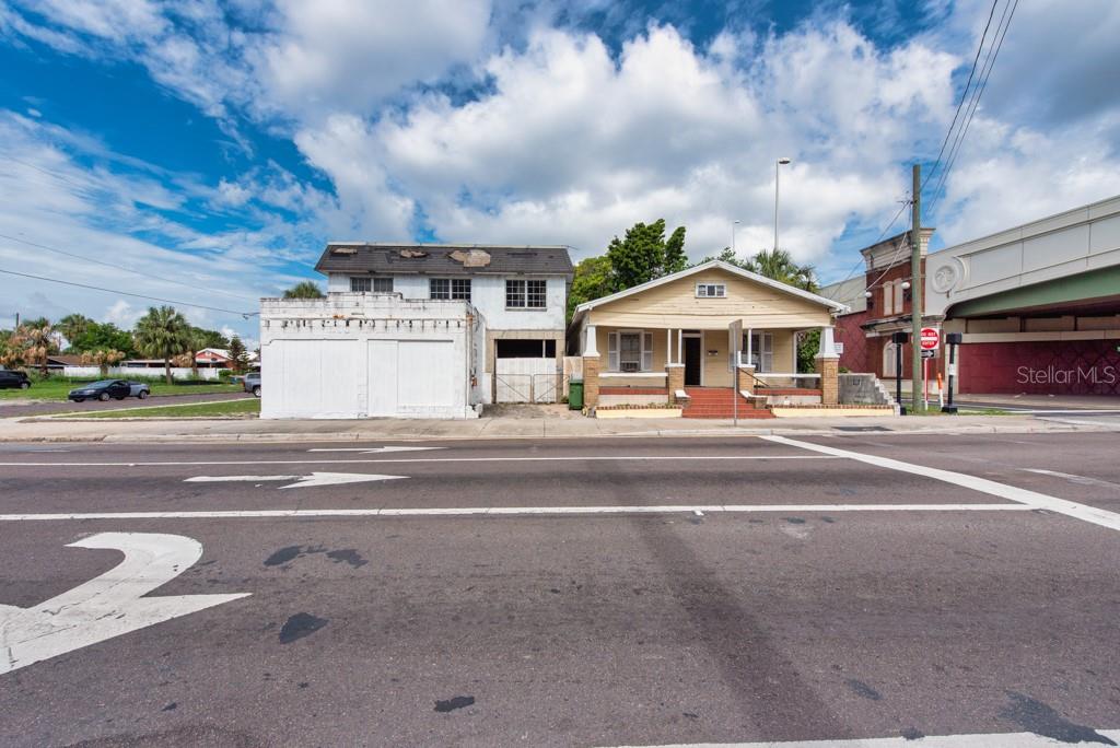 A two-story white building and a yellow bungalow sit side-by-side along a paved road — 1406 N HOWARD AVENUE, TAMPA, FL