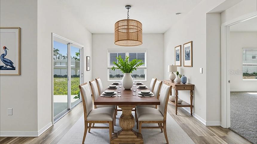 This dining room features a wooden table, six upholstered chairs, and a woven pendant light — 24258 NW 13TH BOULEVARD, NEWBERRY, FL