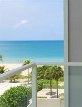 A balcony view overlooking a sandy beach, palm trees, and the ocean — 1000 S Ocean Boulevard # 6n, Pompano Beach FL 33062, POMPANO BEACH, FL