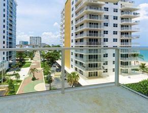 A balcony view overlooking a paved walkway, palm trees, and high-rise buildings near the ocean — 1000 S Ocean Boulevard # 6n, Pompano Beach FL 33062, POMPANO BEACH, FL