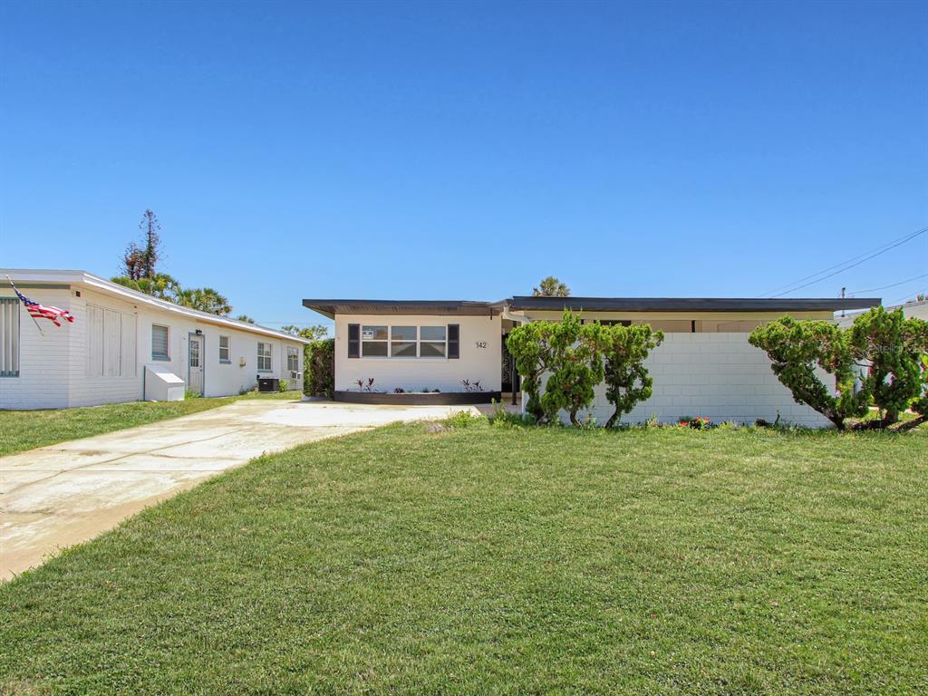 A single-story house with a white exterior, a flat roof, and a front lawn — 342 BOYLSTON AVENUE, DAYTONA BEACH, FL