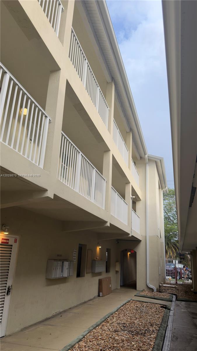 An exterior view of a multi-story apartment building with white railings and a walkway — 1025 SW 7th Ave # 6, Miami FL 33130, MIAMI, FL