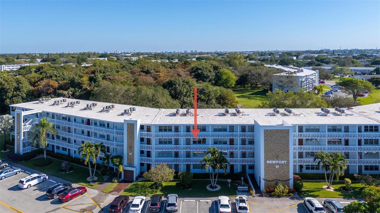 An aerial view of a multi-story apartment building with a red arrow pointing to a unit — 3028 Newport H, Deerfield Beach FL 33442, DEERFIELD BEACH, FL